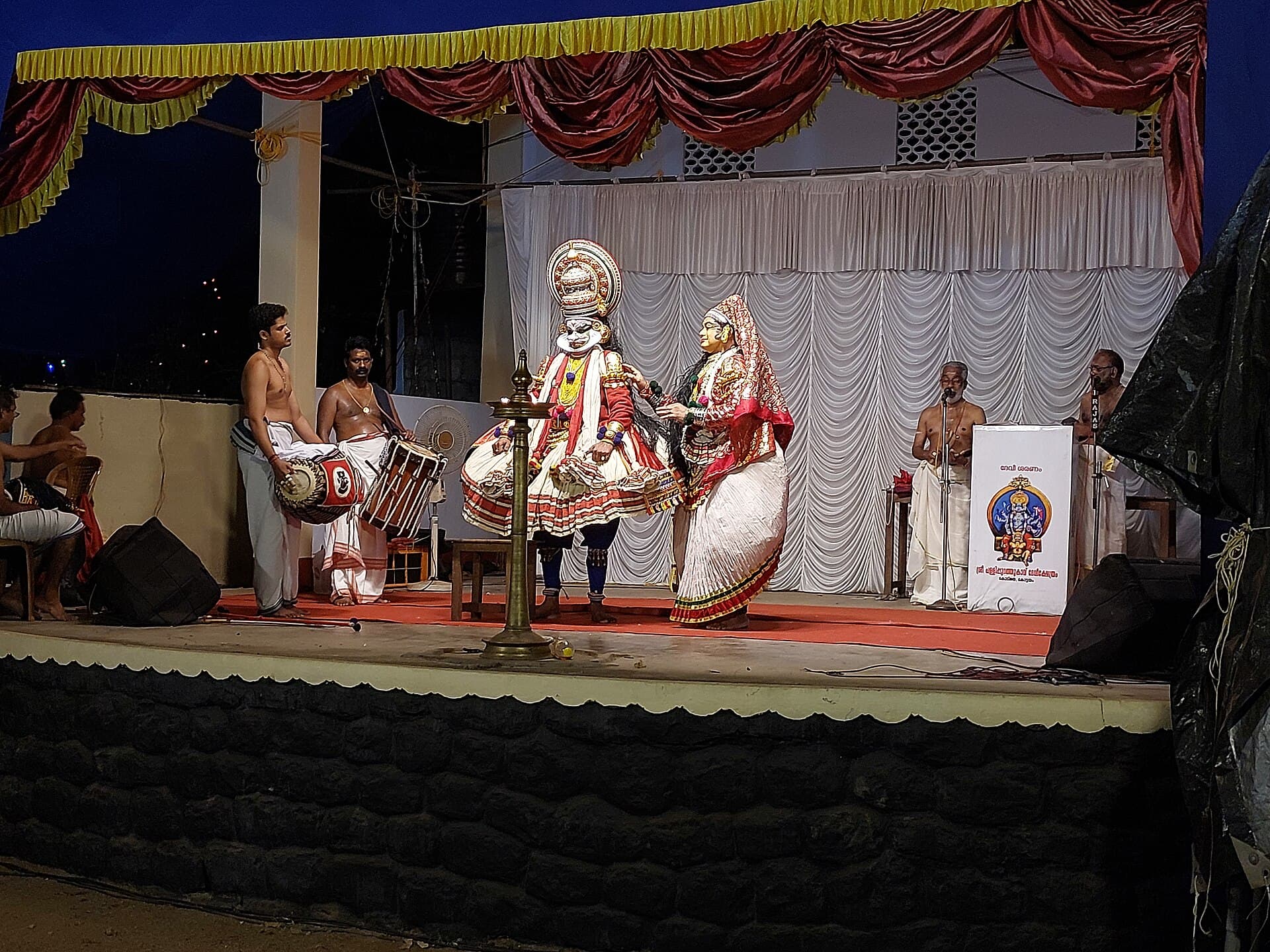 A Kathakali performer in green facial make-up at a temple festival in Kottayam