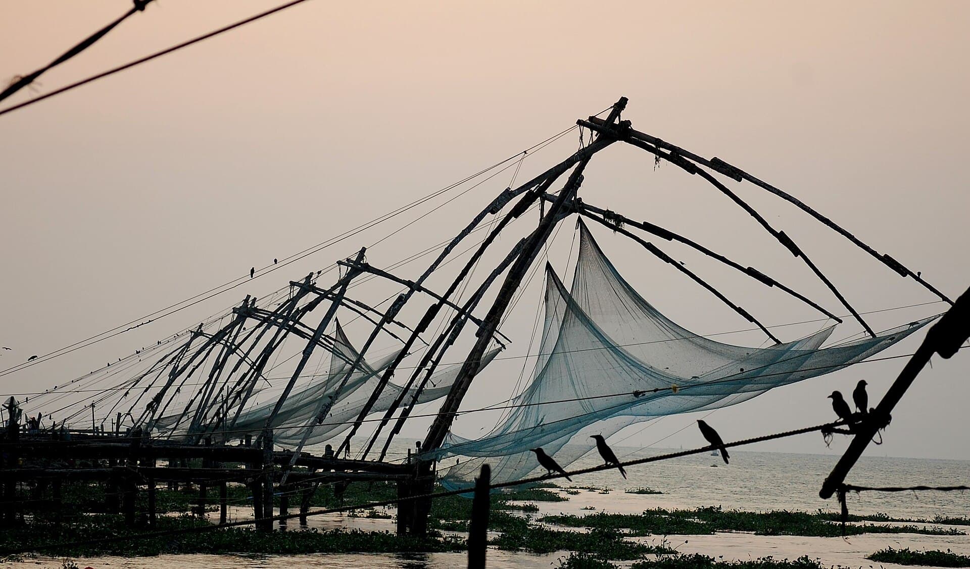 Chinese fishing nets silhouetted against the sky at Fort Kochi