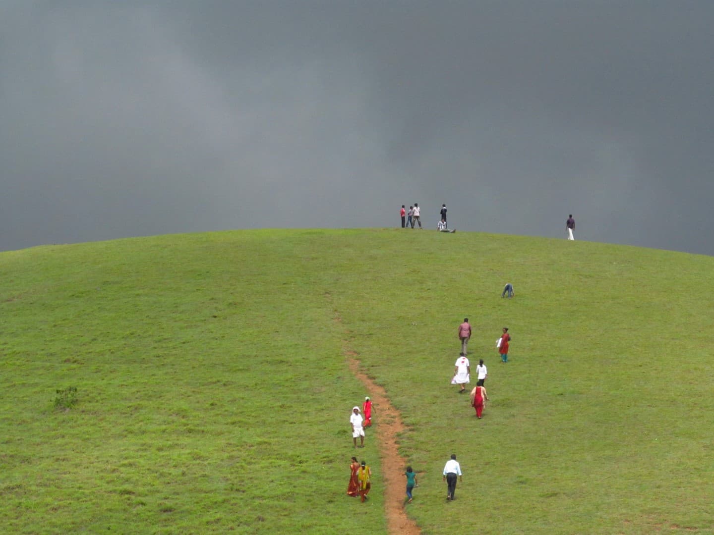 Rolling grass-covered hills at Vagamon under a cloudy sky
