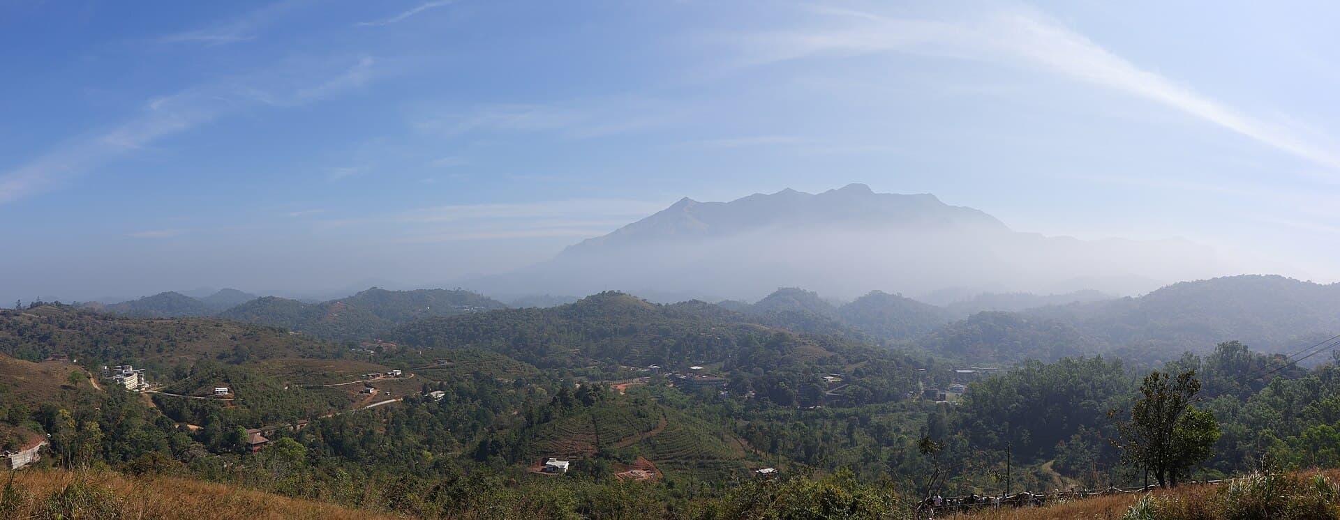 Chembra Peak in Wayanad viewed across green hills